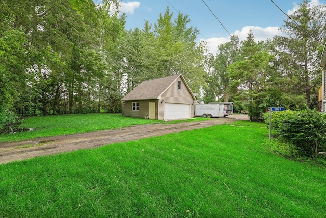 exterior space with a garage and an outbuilding