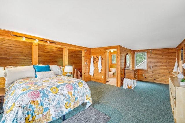 bedroom featuring wooden walls, carpet floors, and ensuite bathroom