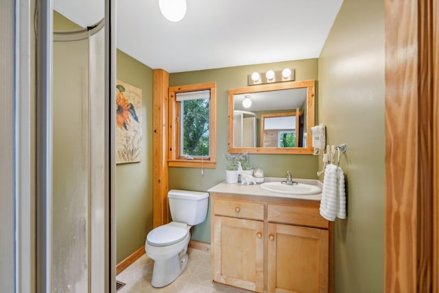 full bathroom with baseboards, vanity, and toilet