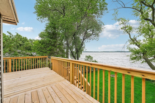 wooden deck featuring a water view and a yard