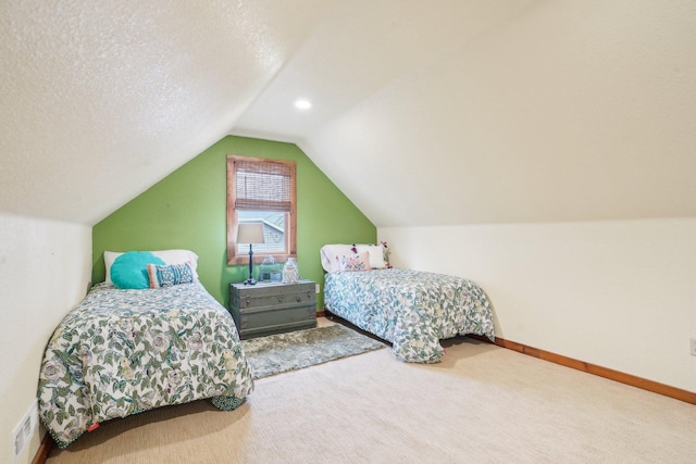 bedroom featuring carpet floors, baseboards, a textured ceiling, and lofted ceiling