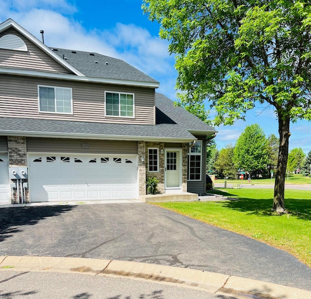 11215 16th St NE, Saint Michael, MN 55376 - view of front of property with a front lawn, roof with shingles, asphalt driveway, and a garage