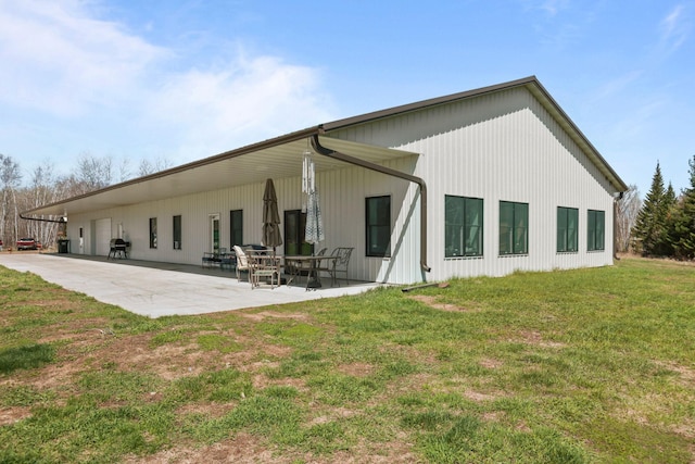 back of property featuring a lawn and a patio