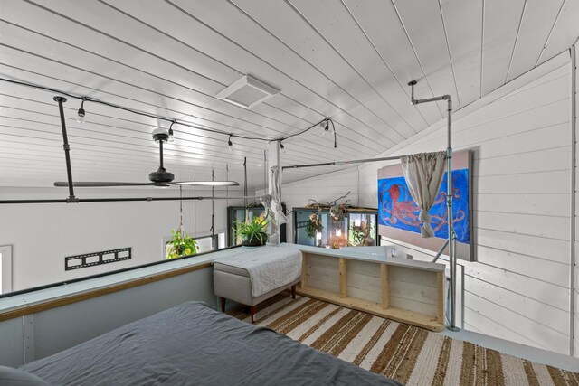 bedroom with wooden walls and carpet