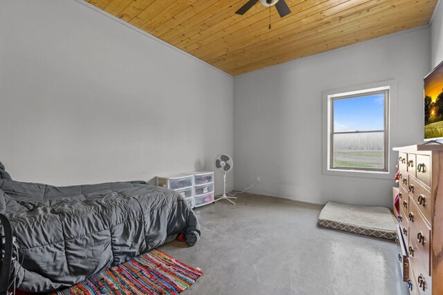 bedroom with a ceiling fan, concrete floors, and wooden ceiling