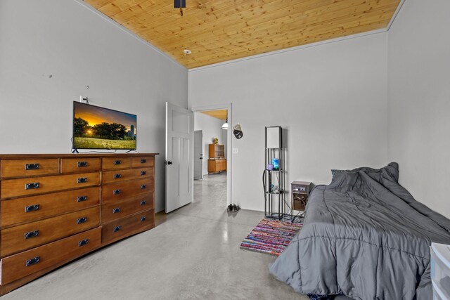 bedroom with wooden ceiling, a high ceiling, and concrete floors
