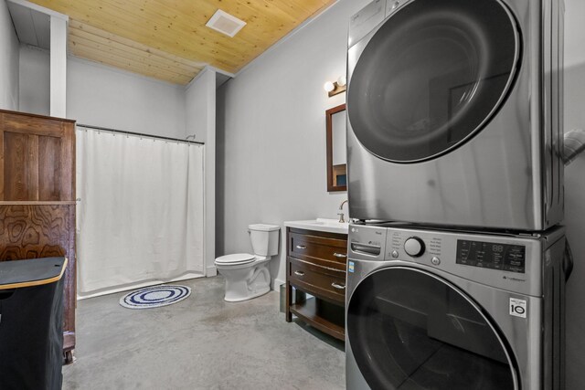 washroom with stacked washer and dryer, a sink, visible vents, and wood ceiling