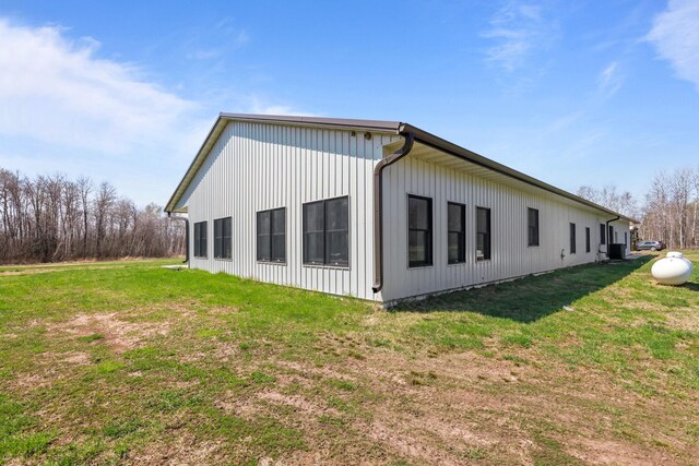 view of home's exterior with a yard and central AC unit