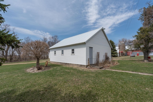 view of home's exterior featuring a yard and metal roof
