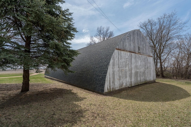 view of barn with a lawn