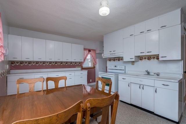 kitchen featuring electric stove, a textured ceiling, white cabinetry, light countertops, and under cabinet range hood