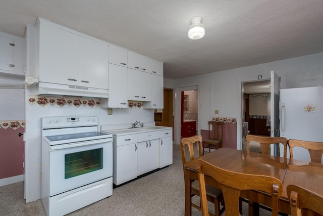 kitchen featuring white cabinets, under cabinet range hood, light countertops, white appliances, and light colored carpet
