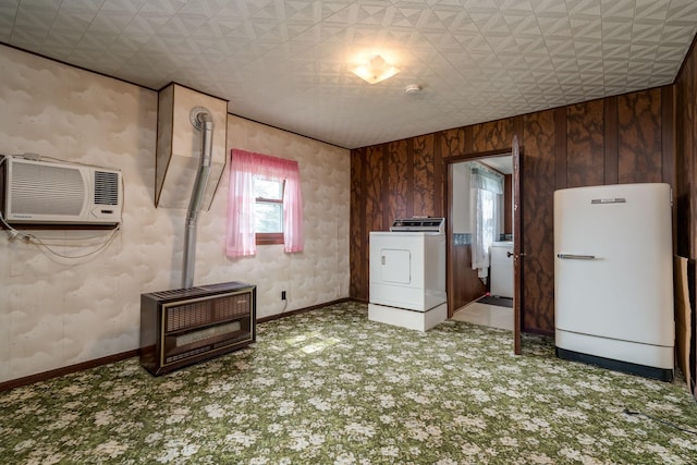 interior space featuring heating unit, a wall unit AC, carpet floors, and washer / clothes dryer