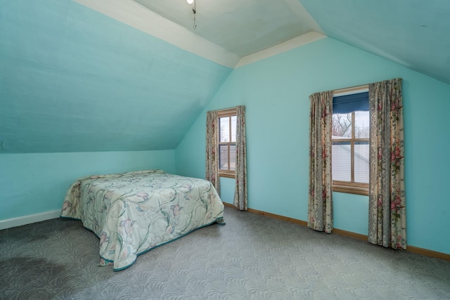 bedroom featuring baseboards, vaulted ceiling, and carpet flooring