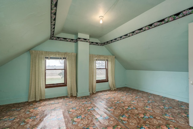 bonus room featuring vaulted ceiling and carpet floors