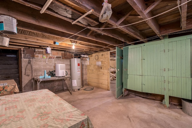 unfinished below grade area featuring water heater