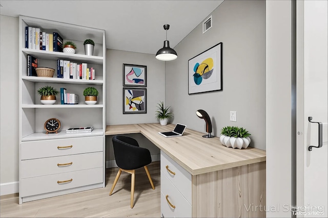 office area featuring built in study area and light wood finished floors