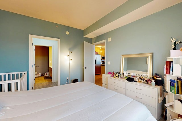 bedroom with stainless steel fridge
