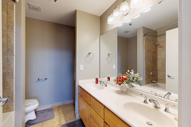 bathroom with toilet, tile patterned floors, shower / tub combination, double vanity, and baseboards
