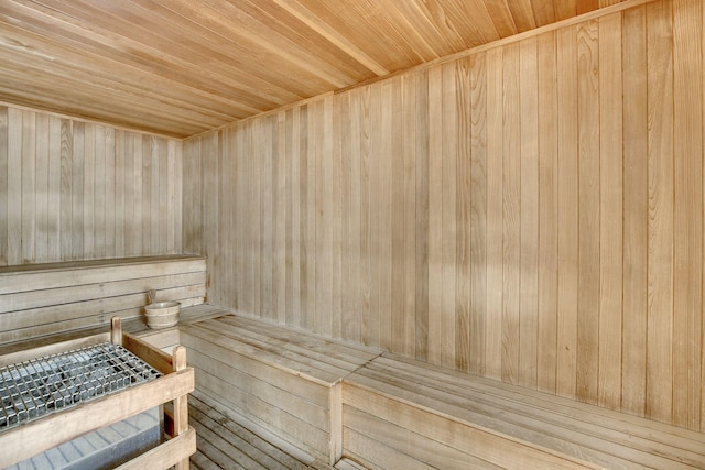 sauna / steam room with wood ceiling and wood walls