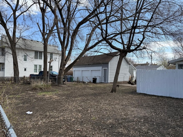 view of yard with an outdoor structure and fence