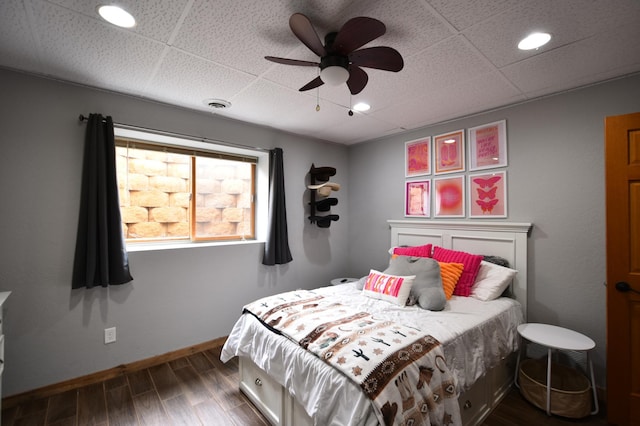 bedroom with dark wood finished floors, baseboards, visible vents, and a ceiling fan