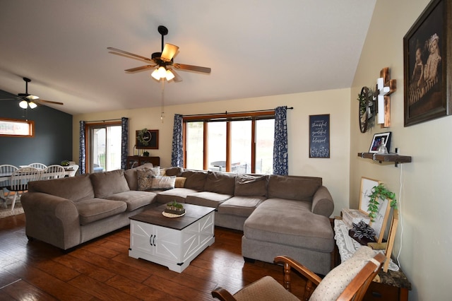 living area featuring a ceiling fan, lofted ceiling, and dark wood-type flooring