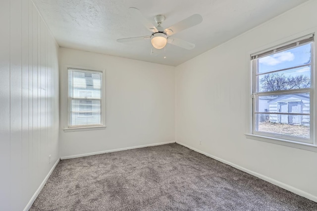 carpeted empty room with baseboards and ceiling fan