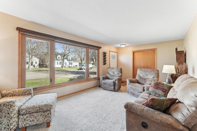 living area with a wealth of natural light, carpet flooring, and baseboards