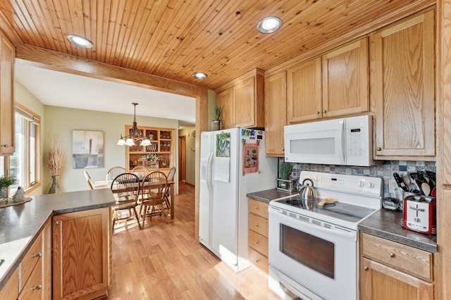 kitchen with light wood finished floors, dark countertops, white appliances, and recessed lighting