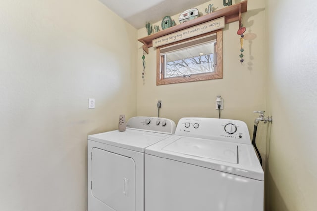 laundry room featuring separate washer and dryer and laundry area