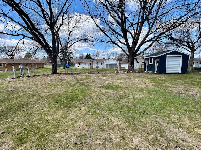 view of yard with fence and an outbuilding