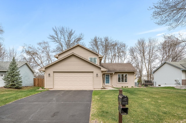 traditional-style home featuring roof with shingles, a front yard, fence, aphalt driveway, and an attached garage