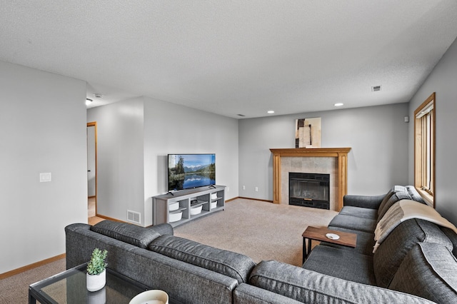living room with carpet floors, visible vents, baseboards, recessed lighting, and a tiled fireplace