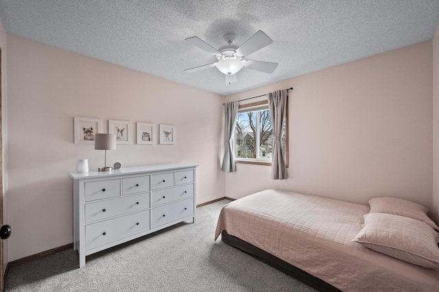 bedroom with a textured ceiling, baseboards, light colored carpet, and a ceiling fan