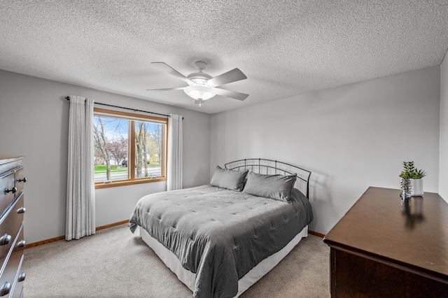 carpeted bedroom with baseboards and a ceiling fan