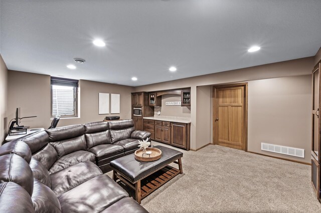 living area with visible vents, recessed lighting, baseboards, and carpet floors