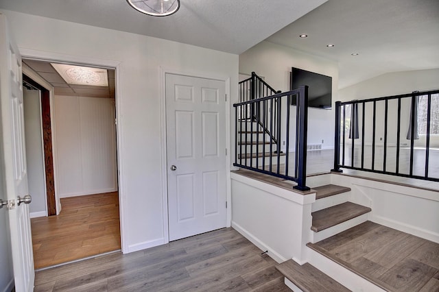25755 E Comfort Dr, Wyoming, MN 55013 - stairway featuring recessed lighting, vaulted ceiling, wood finished floors, and baseboards