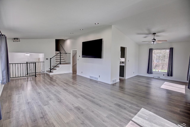 25755 E Comfort Dr, Wyoming, MN 55013 - unfurnished living room featuring wood finished floors, visible vents, a ceiling fan, and baseboards