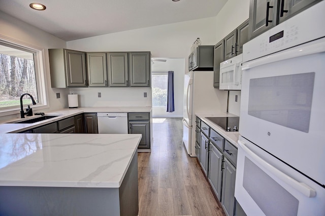 25755 E Comfort Dr, Wyoming, MN 55013 - kitchen featuring a sink, lofted ceiling, white appliances, gray cabinets, and light stone countertops
