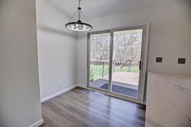 25755 E Comfort Dr, Wyoming, MN 55013 - unfurnished dining area with baseboards, a chandelier, wood finished floors, and visible vents
