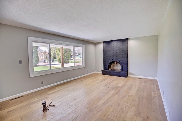 25755 E Comfort Dr, Wyoming, MN 55013 - unfurnished living room with visible vents, light wood finished floors, and baseboards