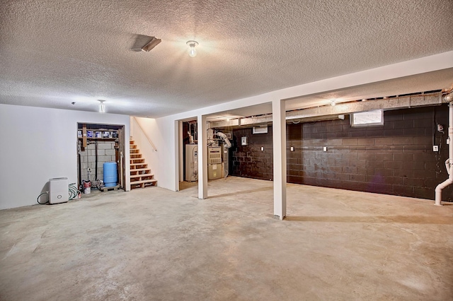 25755 E Comfort Dr, Wyoming, MN 55013 - basement featuring concrete block wall, a textured ceiling, stairs, and gas water heater