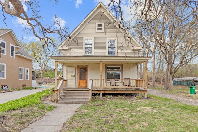view of front of house with stucco siding and a porch