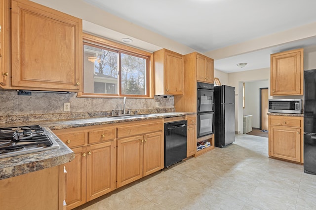kitchen with a sink, decorative backsplash, and black appliances