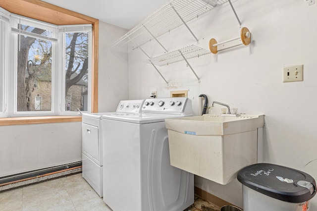 washroom featuring independent washer and dryer, laundry area, and a sink