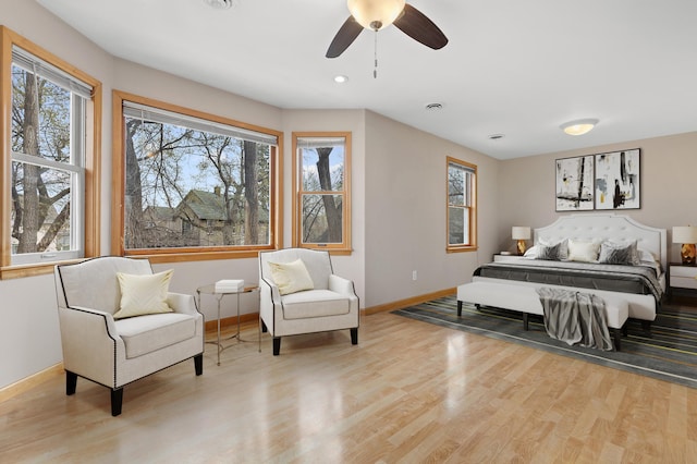bedroom featuring baseboards, a ceiling fan, and wood finished floors