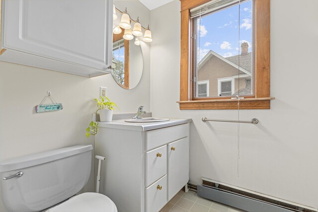 bathroom with vanity, a baseboard radiator, and toilet