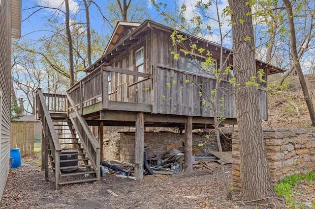 view of property exterior featuring a wooden deck and stairs