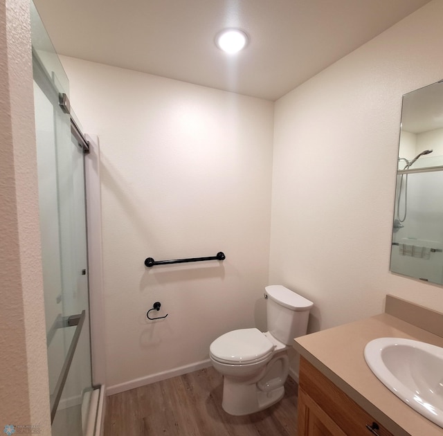 409 Prairieview St, St Thomas, ND 58276 - full bath featuring recessed lighting, wood finished floors, a shower with shower door, toilet, and vanity